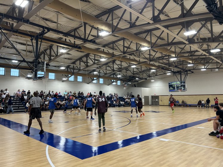 Players and a full set of stands during an exhibition basketball game in the restored Holy Name Alumni Field House
